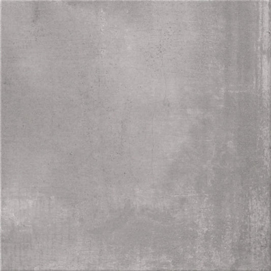 alt='Pavimento quadrado de 60x60cm em grés porcelânico com efeito de cimento em tom de cinza claro mate.'