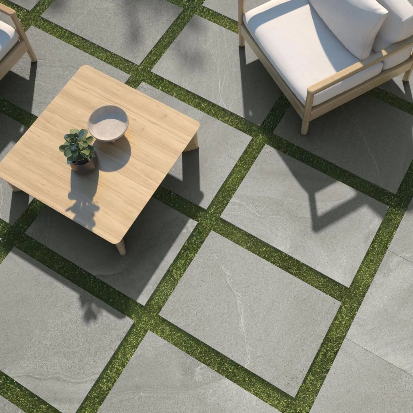 alt='Lajes de pavimento Pamesa Burlingstone Gris de 20mm instaladas como caminho sobre um relvado num jardim.'